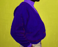 African American male wearing purple sweater and yellow hat