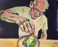 Older white male sprinkling salt on a piece of toast.