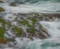 Waves crashing against rocky coast.