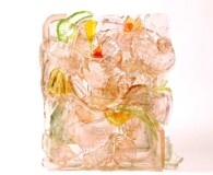 Coral-toned glass pieces shaped into 3-D sculpture.